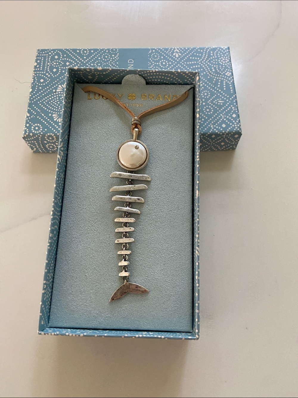 Lucky Brand Silver Fishbone Pendant with Cream Disc on Tan Cord
